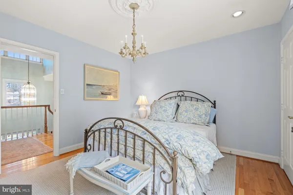 a bedroom with a bed window and a table