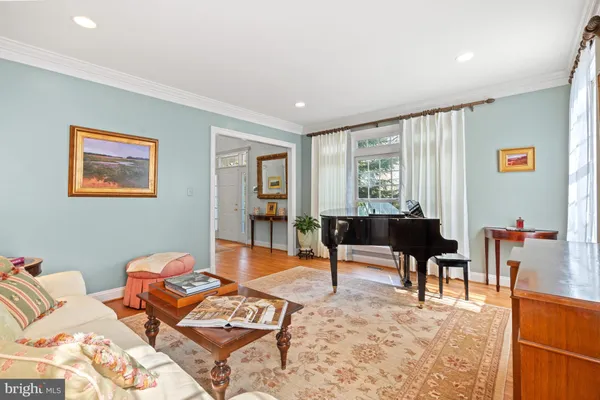 a living room with furniture a rug and a window