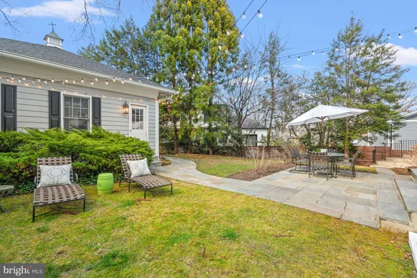 a view of a house with backyard porch and sitting area