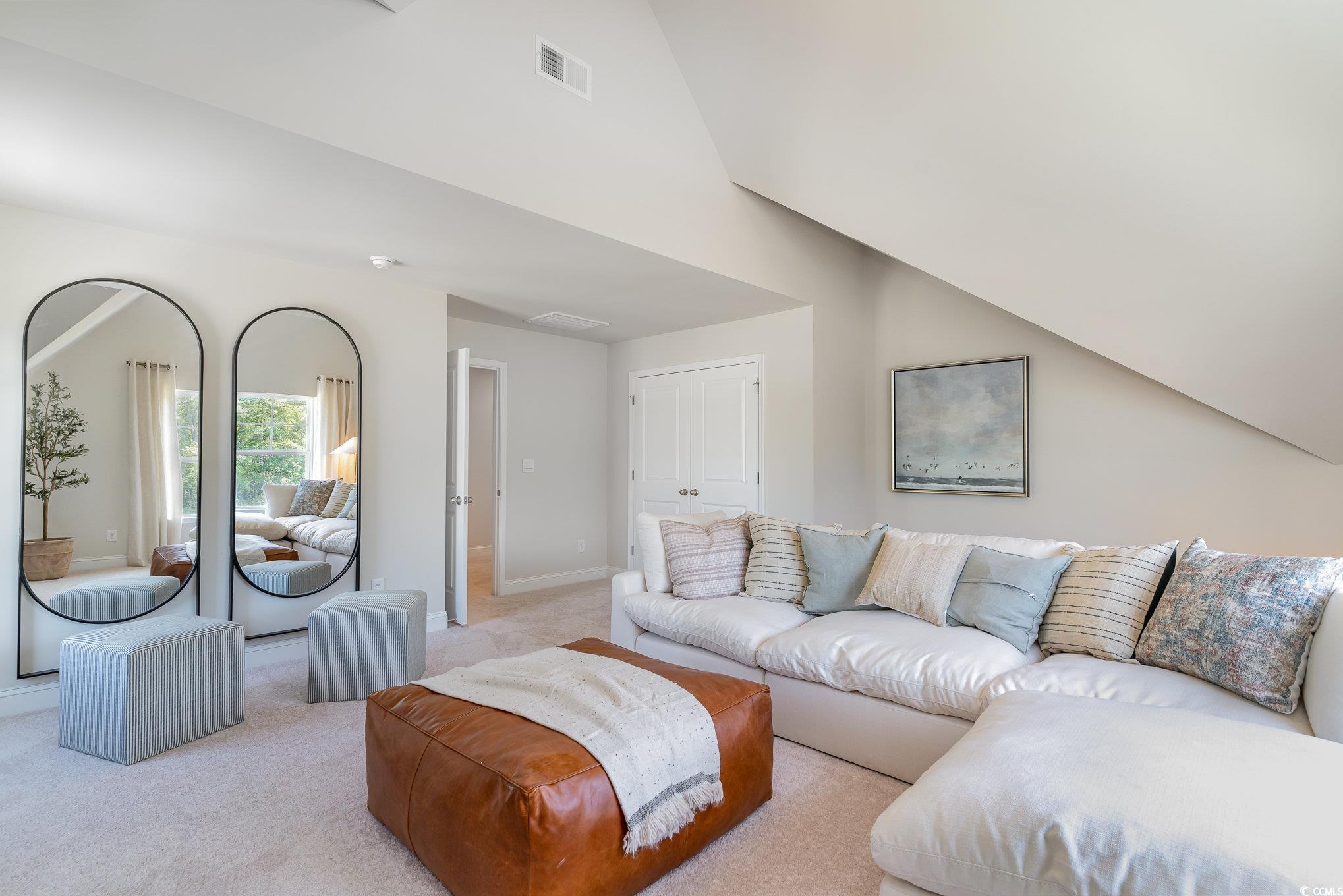534 Haven View Way Murrells Inlet, SC 29576 - Photo 24 of 32 Living room with vaulted ceiling, baseboards, visible vents, and light carpet
