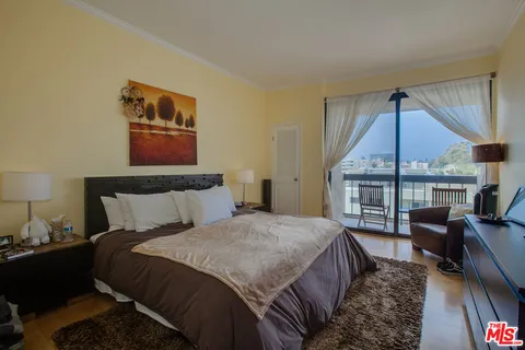 a bedroom with a bed a couch and dresser