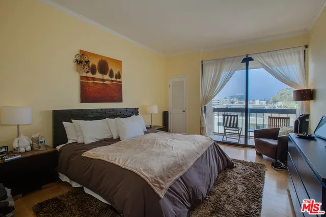 a bedroom with a bed a couch and dresser