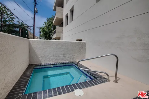 a view of a backyard with furniture and an umbrella