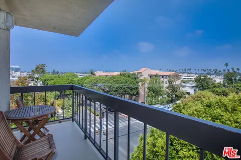a view of a balcony with chairs