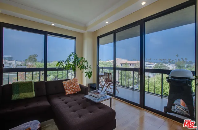 a living room with furniture and a floor to ceiling window