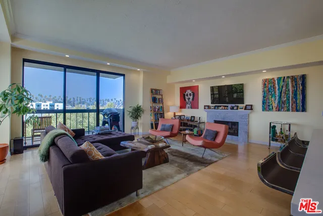 a living room with furniture large window and flat screen tv