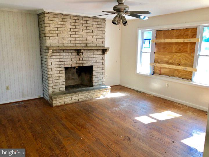 8307 Reno Monument Road Middletown, MD 21769 - Photo 4 of 16 an empty room with windows and fireplace