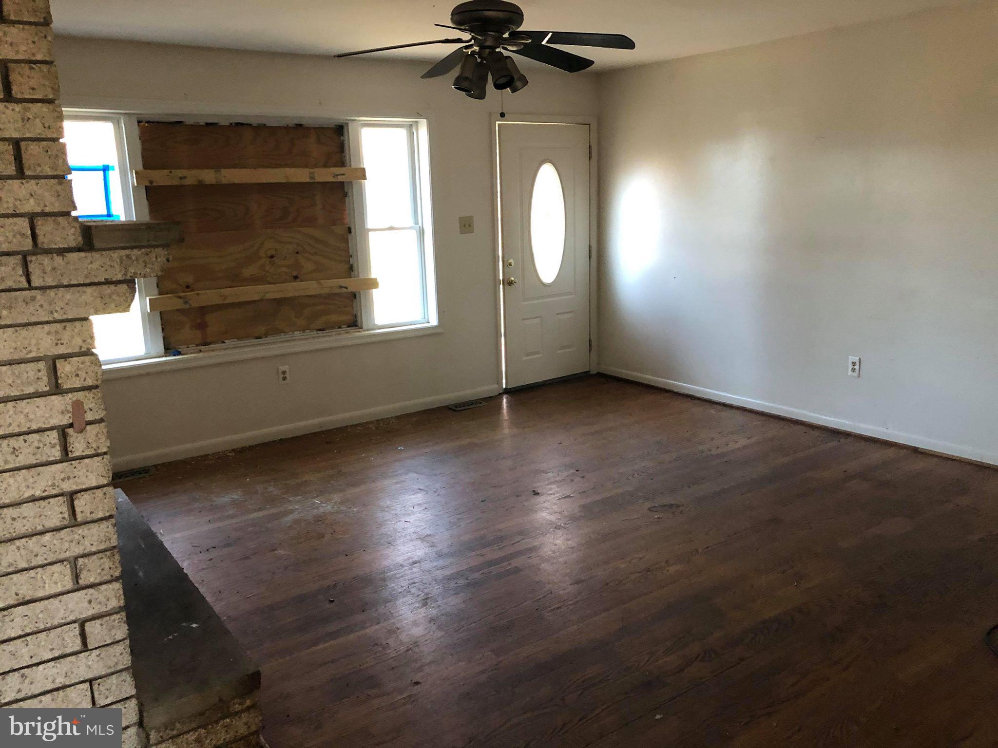 8307 Reno Monument Road Middletown, MD 21769 - Photo 5 of 16 an empty room with wooden floor fan and windows