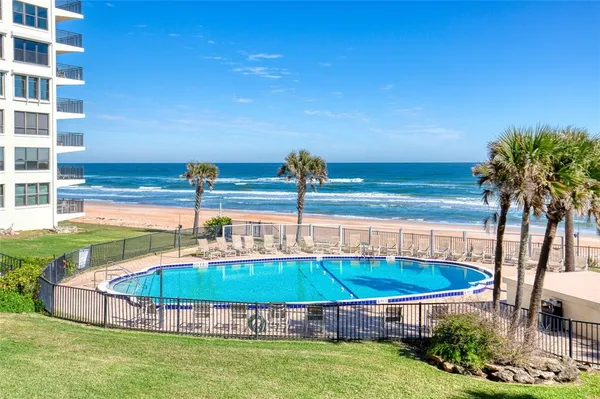 a view of a swimming pool with a patio