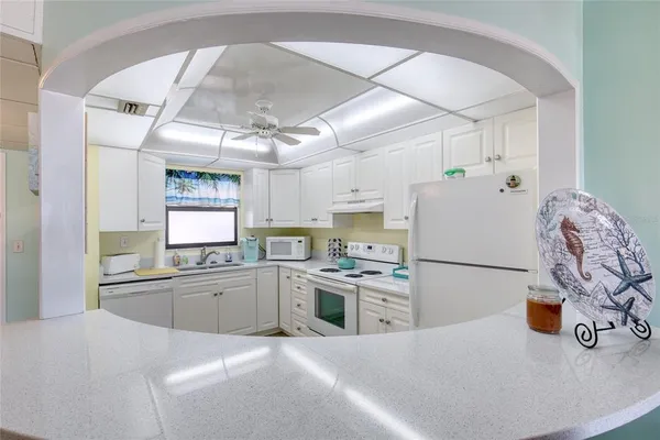 a kitchen with a sink a stove and refrigerator