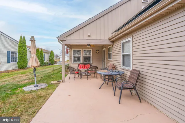 a view of a backyard with a patio and outdoor seating