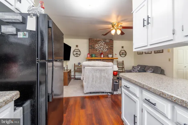 a kitchen that has a lot of cabinets and refrigerator