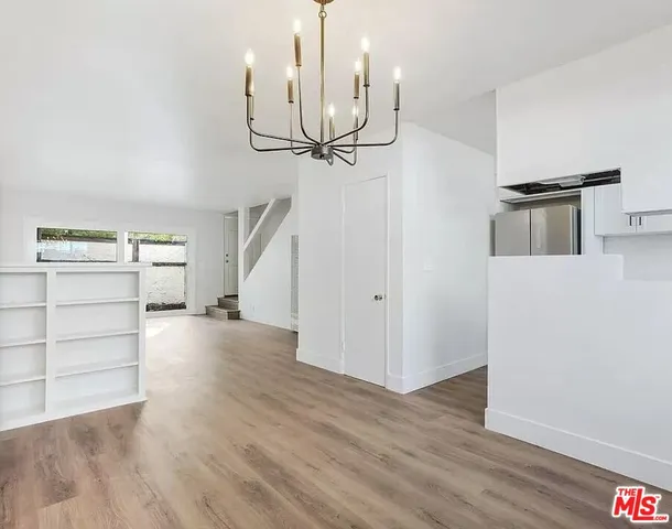 a view of a kitchen with wooden floor and cabinet