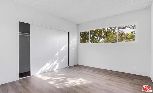 a view of a room with wooden floor and stairs