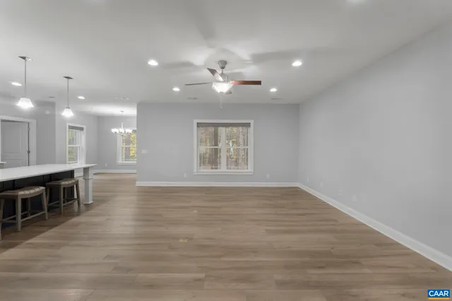 a large kitchen with a table and stainless steel appliances