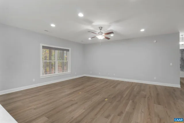 a kitchen with kitchen island a wooden floor and stainless steel appliances