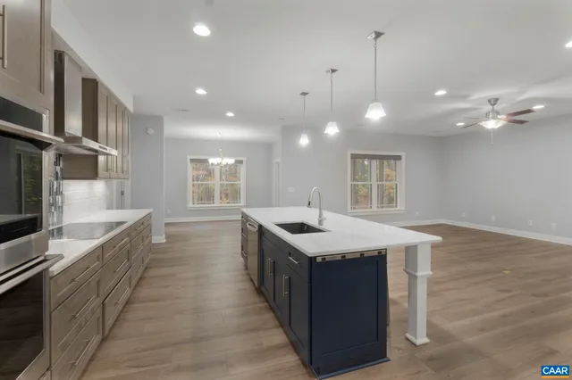 a view of kitchen with wooden floor and cabinets