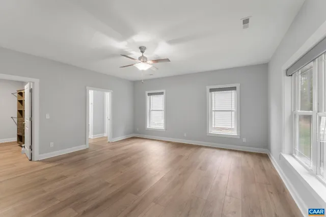 a view of walk in closet with empty racks