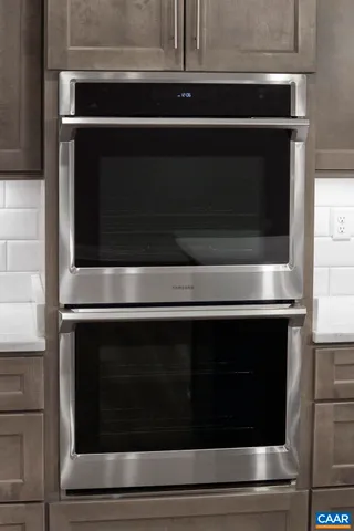 a view of an empty room and window ceiling fan