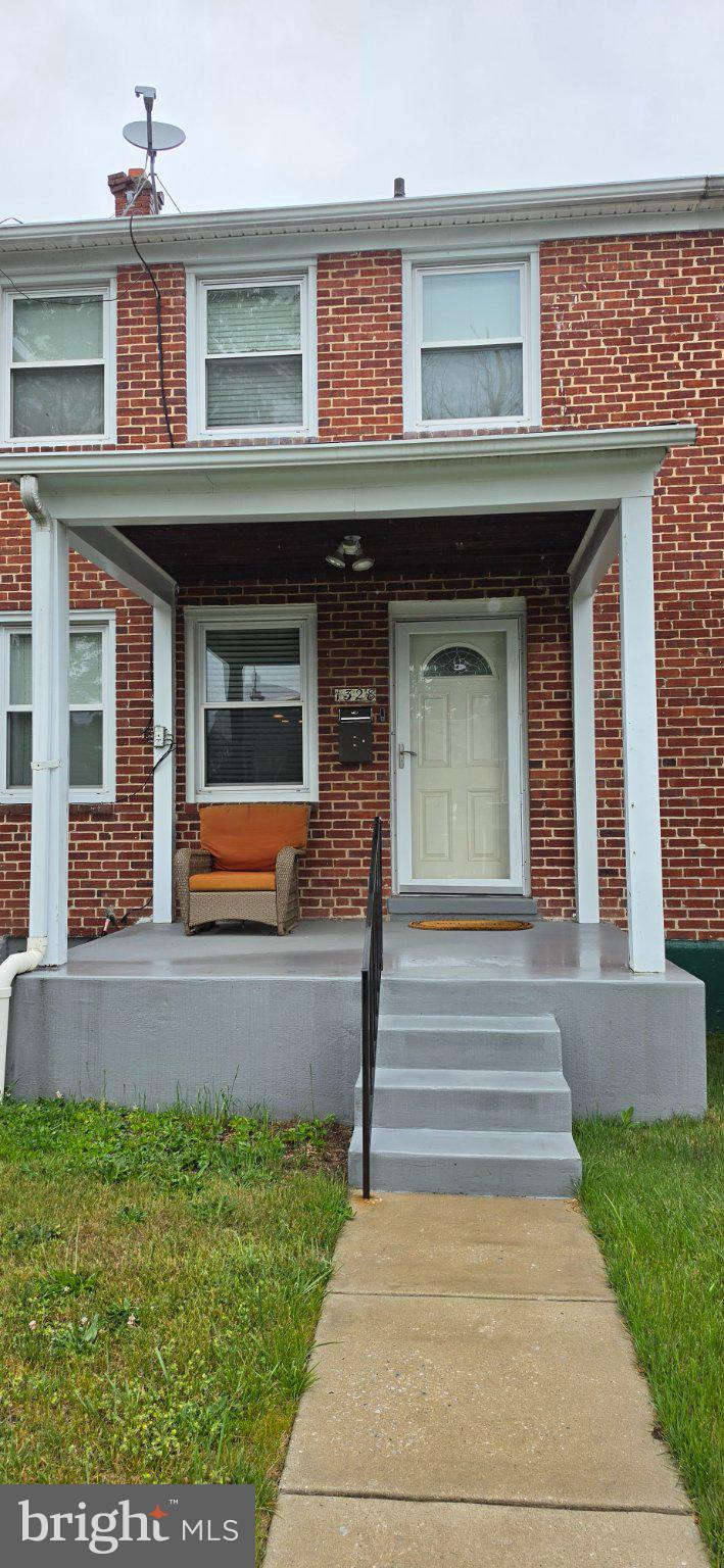 1328 Cedarcroft Road Baltimore, MD 21239 - Photo 1 of 3 a front view of a house with a yard