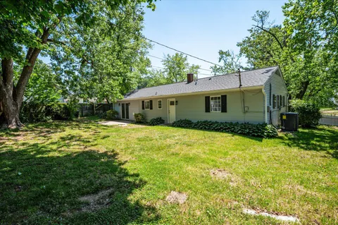 a front view of house with yard and trees