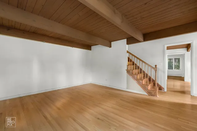 a view of an entryway with wooden floor