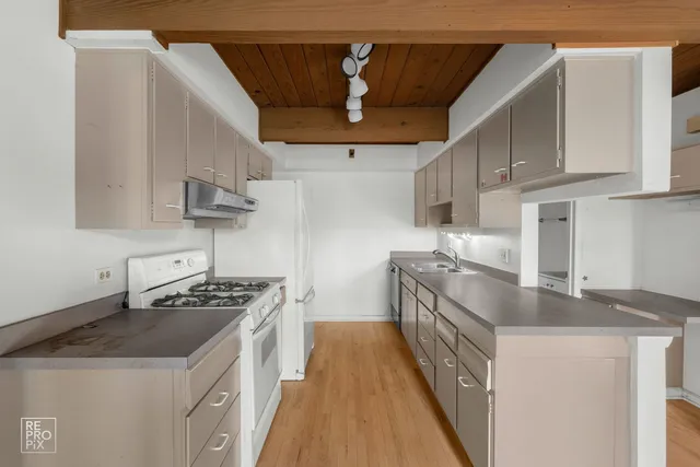a kitchen with stainless steel appliances granite countertop a sink and a stove