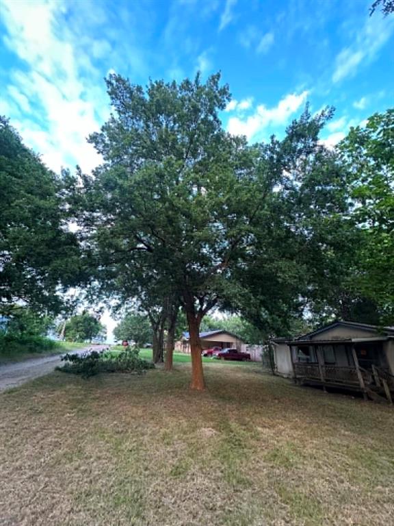 200 West Locust Street Celeste, TX 75423 - Photo 1 of 13 Mature trees provide ample shade over a graded lot with natural ground cover