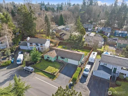 an aerial view of a house with a garden and lake view
