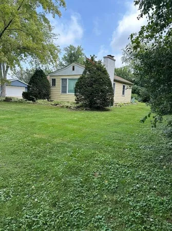 a view of a house with a backyard