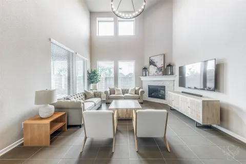 a living room with fireplace furniture and a flat screen tv