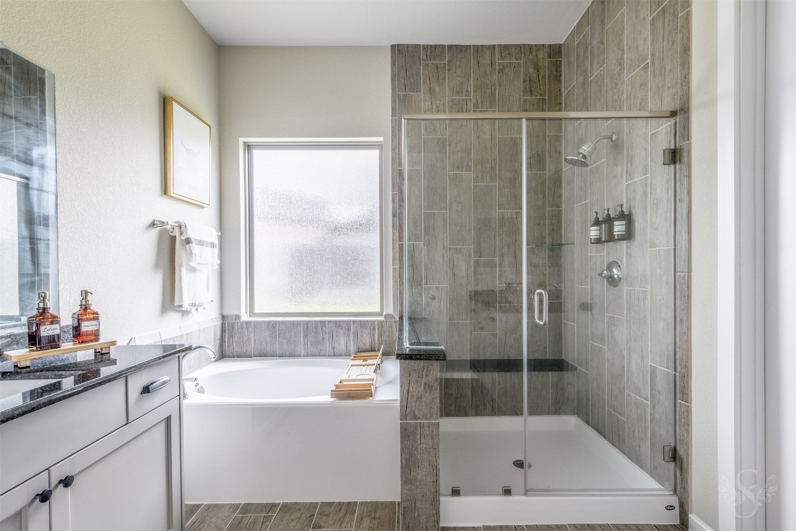 4410 Ana Ridge Lane Fulshear, TX 77441 - Photo 14 of 39 a bathroom with a bathtub a window and a shower
