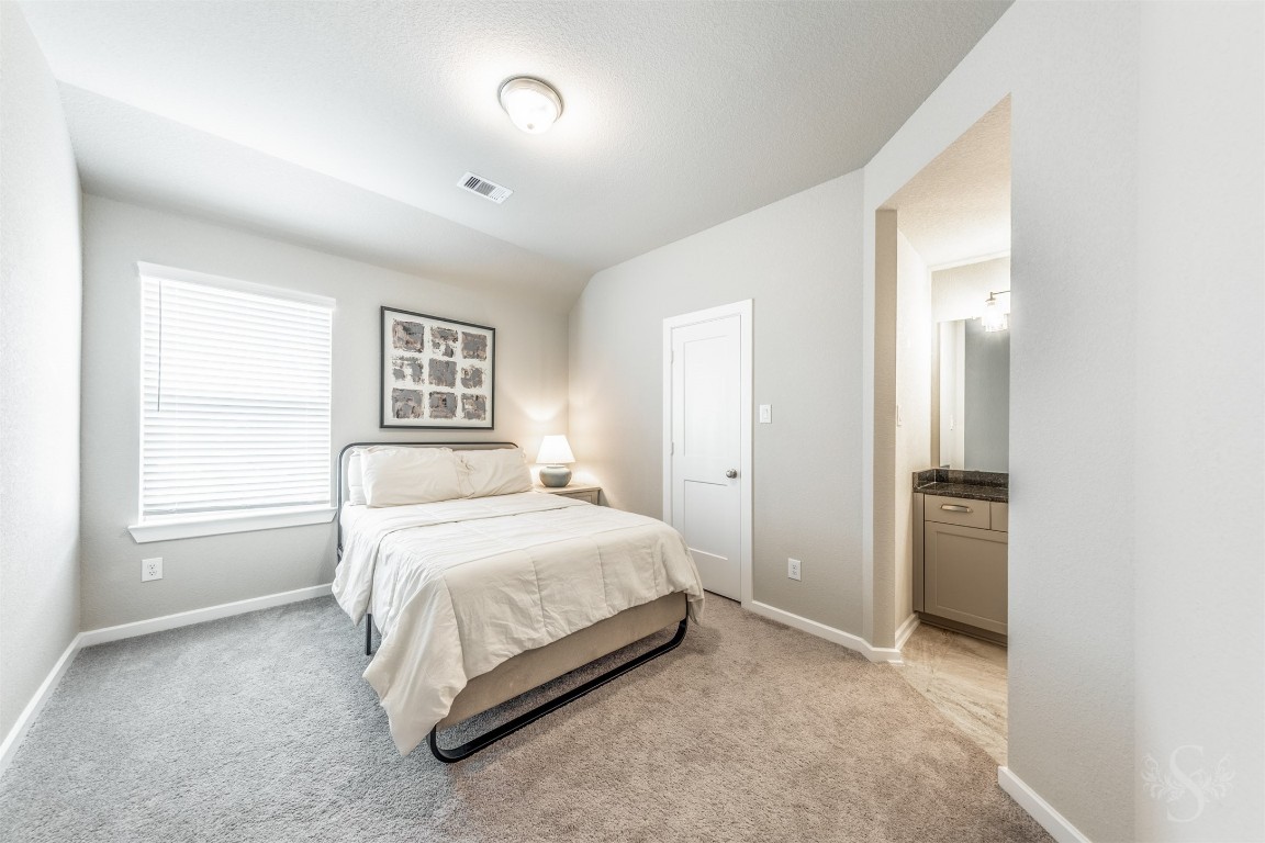 4410 Ana Ridge Lane Fulshear, TX 77441 - Photo 23 of 39 a bedroom with a bed and a window