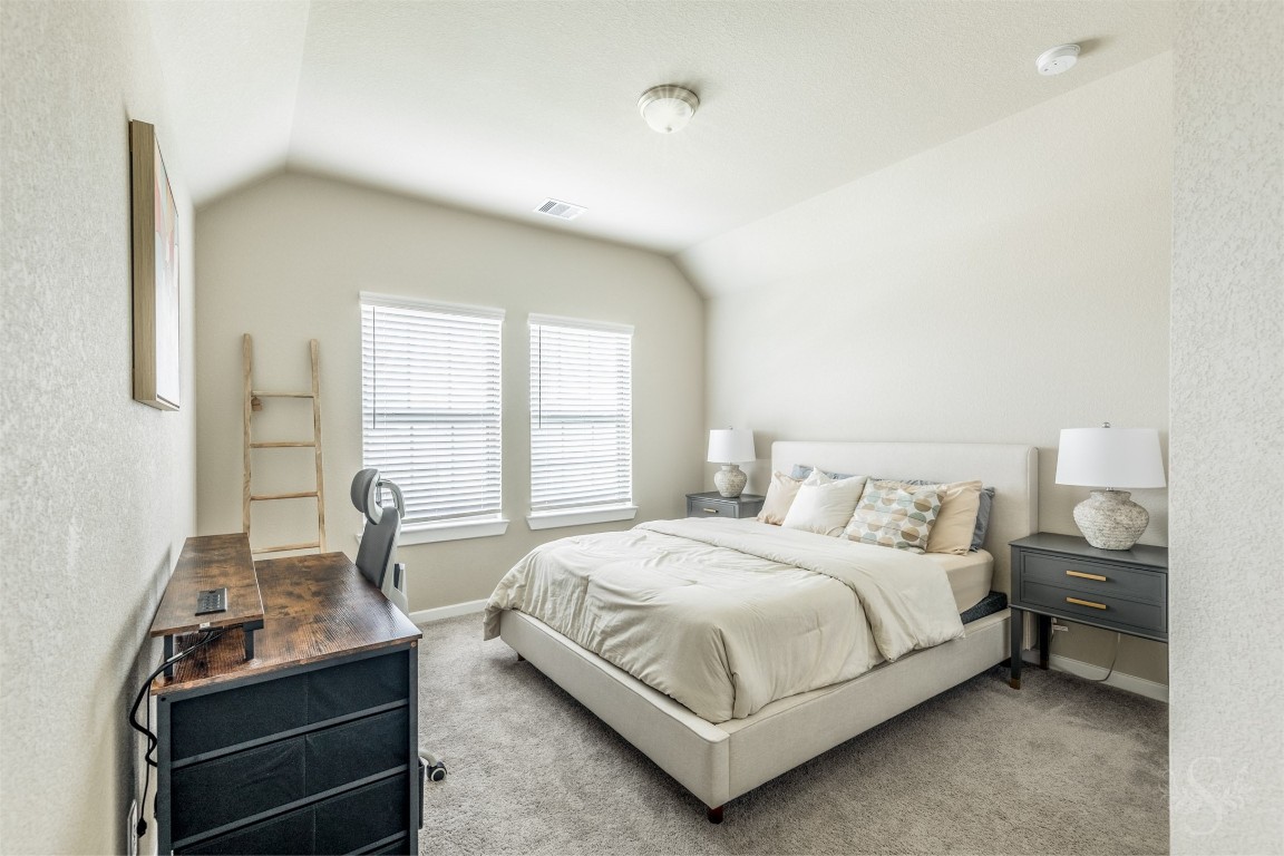 4410 Ana Ridge Lane Fulshear, TX 77441 - Photo 26 of 39 a bedroom with a bed and windows