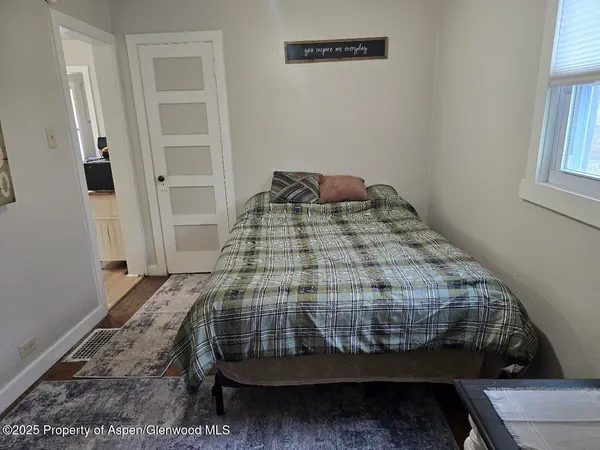 a bedroom with a bed and a window