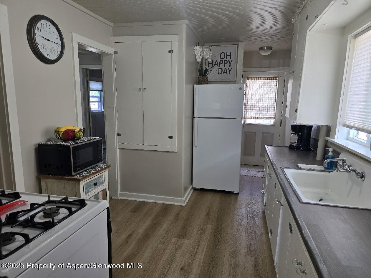 830 Breeze Street Craig, CO 81625 - Photo 3 of 18 a kitchen with a refrigerator and a stove top oven