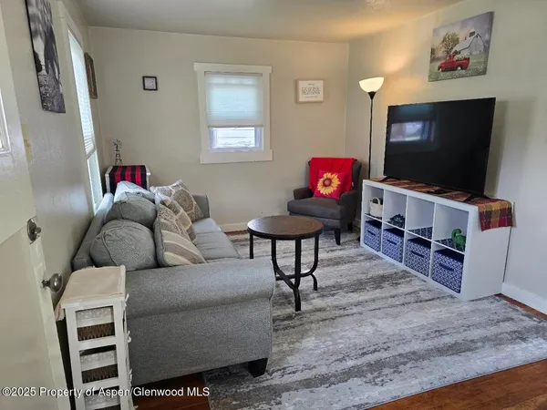 a living room with furniture and a flat screen tv