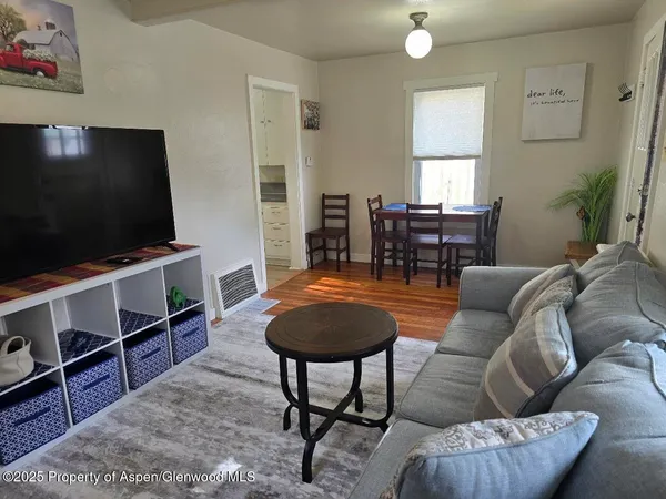 a living room with furniture and a flat screen tv