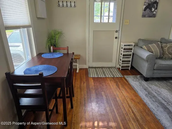 a view of a dining room with furniture and wooden floor