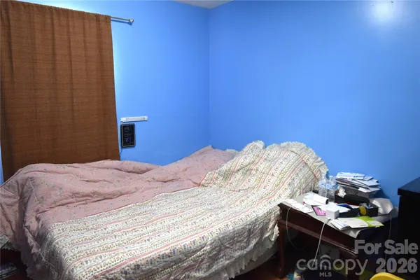 a bedroom with a bed and a table in it