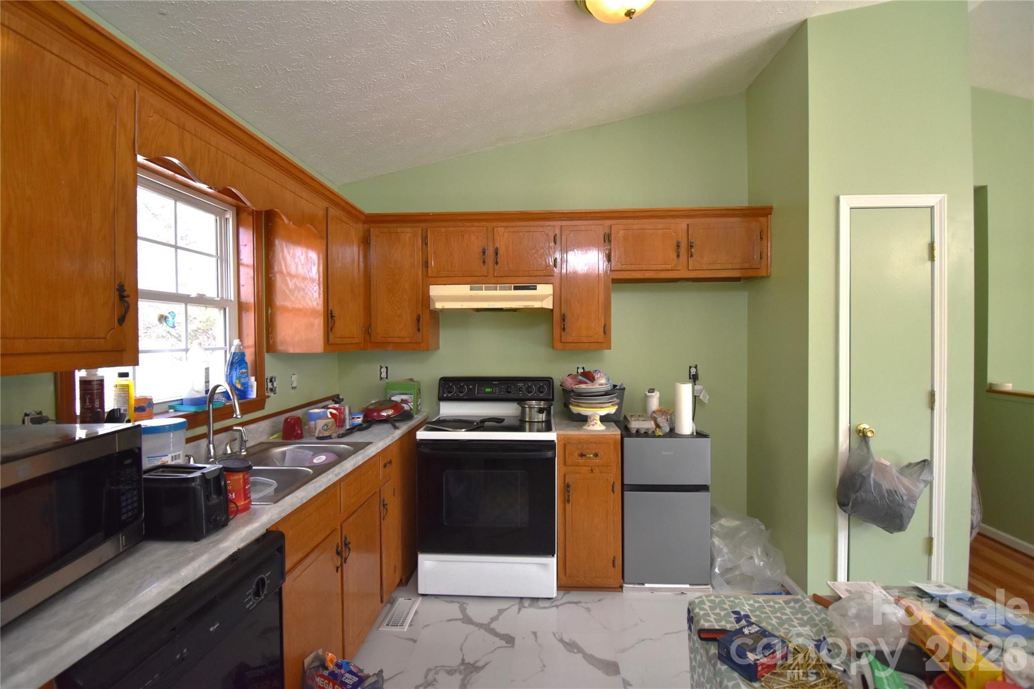 151 Cedar Valley Road Hudson, NC 28638 - Photo 7 of 23 a kitchen with stainless steel appliances granite countertop a sink stove and refrigerator