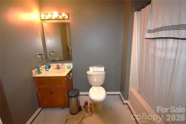 a bathroom with a toilet a sink and a mirror