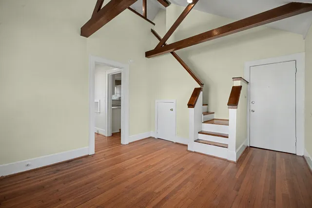 a view of entryway with wooden floor and stairs