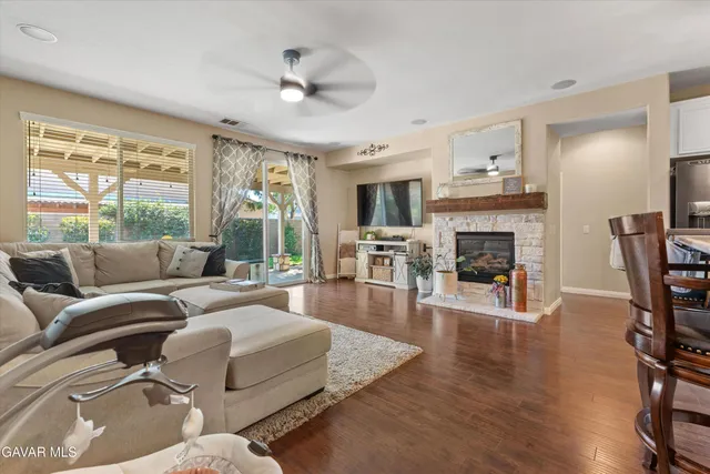 a living room with furniture fireplace and a large window