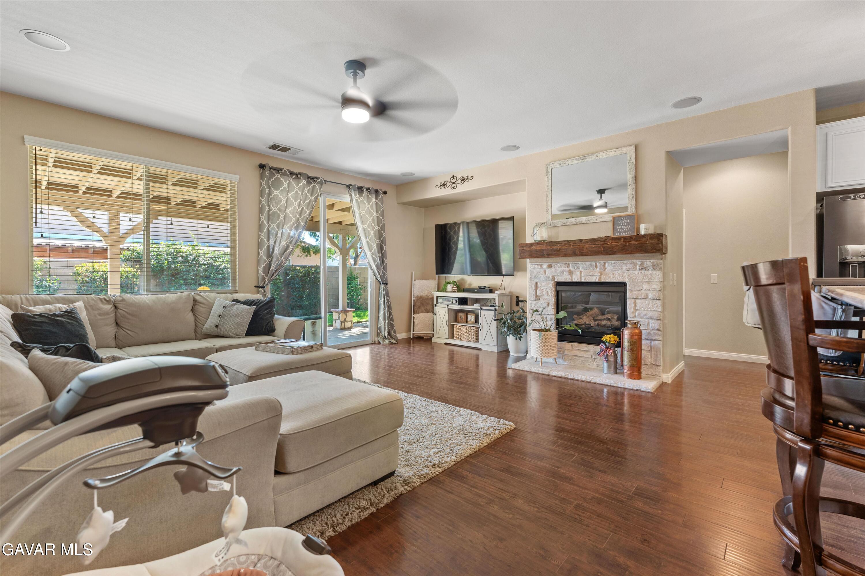 43830 Elena Court Lancaster, CA 93536 - Photo 11 of 22 a living room with furniture fireplace and a large window