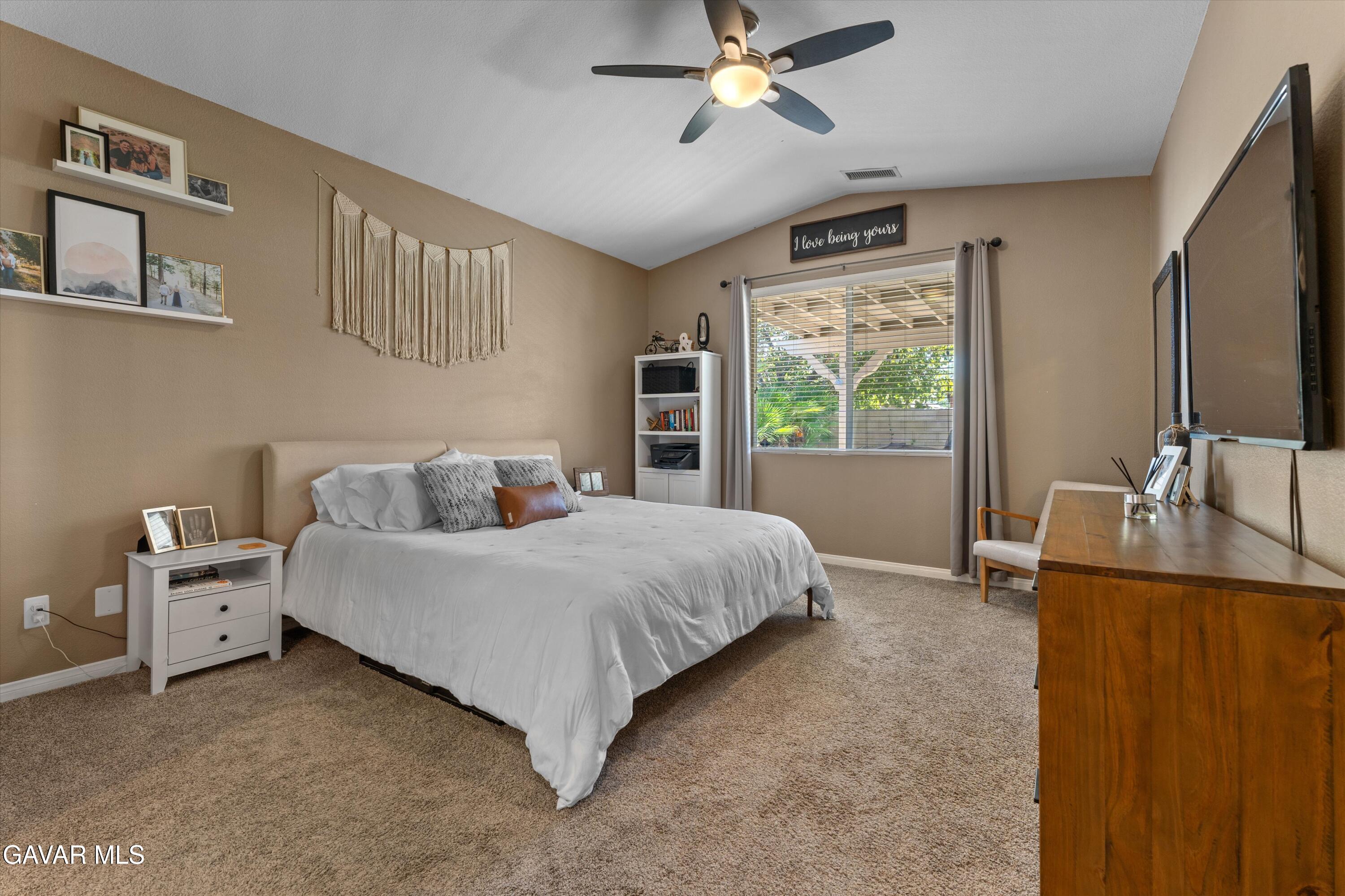 43830 Elena Court Lancaster, CA 93536 - Photo 12 of 22 a bed room with a bed and a chandelier
