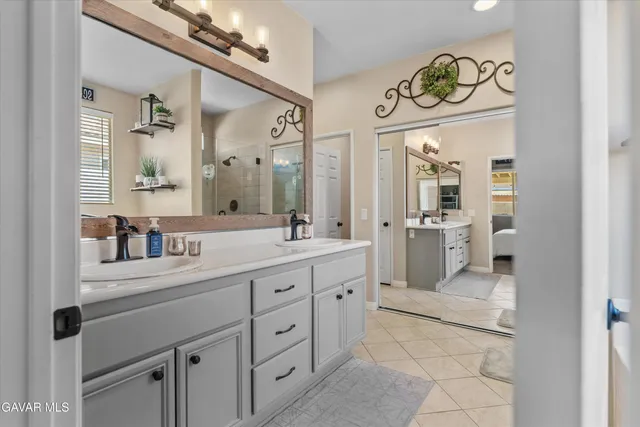 a spacious bathroom with a double vanity sink and a mirror