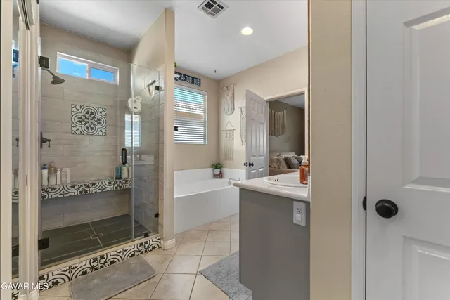 a bathroom with a granite countertop sink mirror and shower
