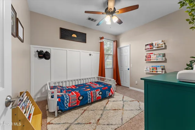 a bedroom with furniture and a flat screen tv