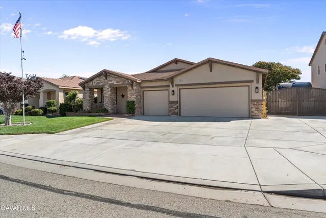 a view of a house next to a yard